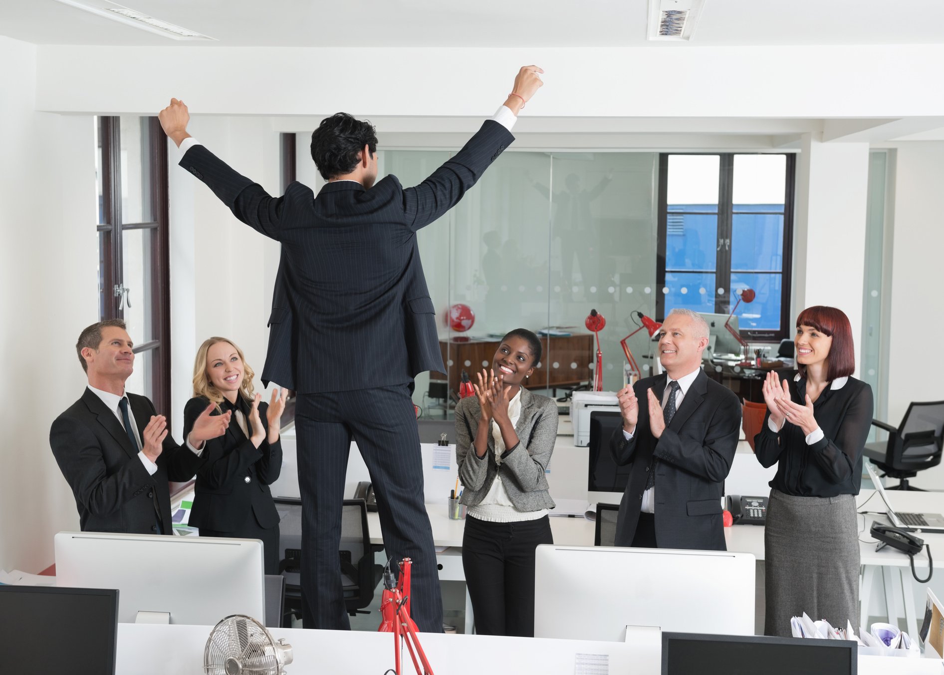 Colleagues Applauding Their Coworker
